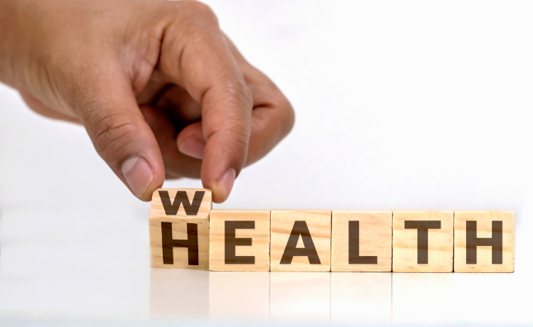 Wooden blocks spelling health and wealth