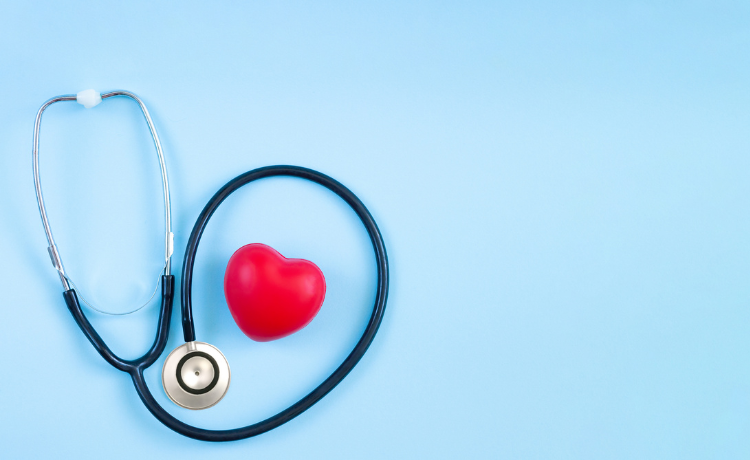 Stethoscope with red heart on blue background